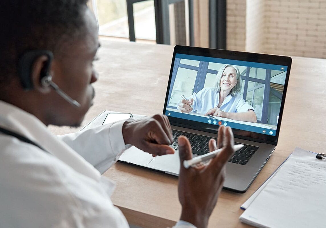 Doctor talking to patient via computer